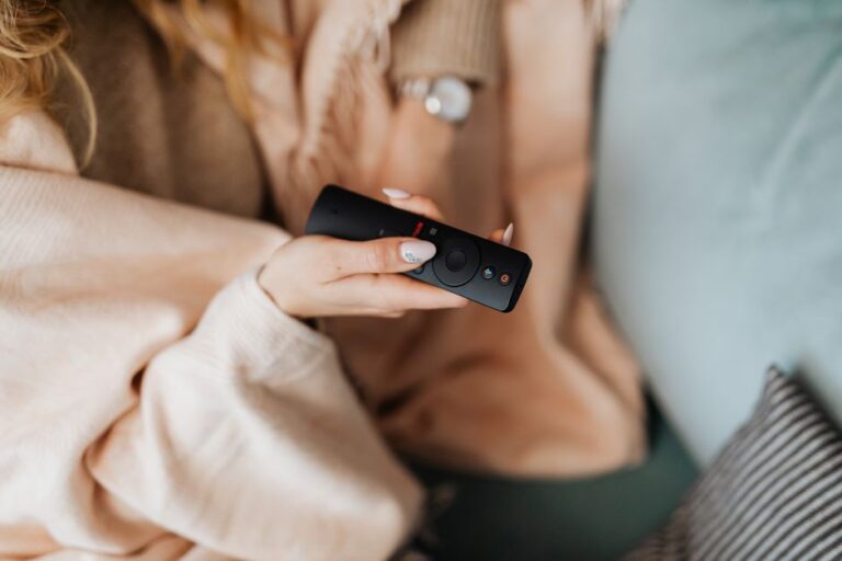Smart TV in a UK living room with a remote control